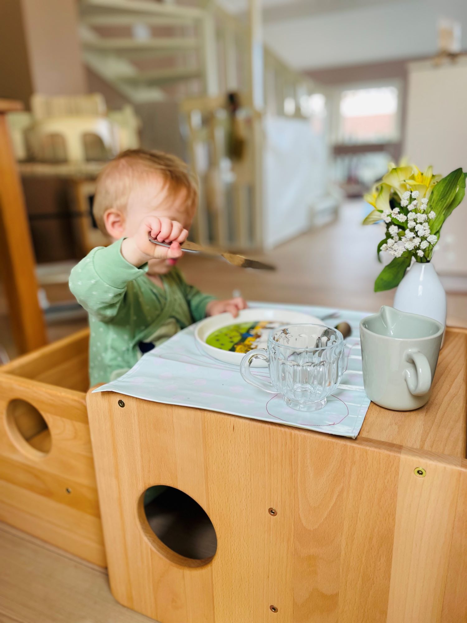 N bruker ekte bestikk. Merk at poenget ikke er at hun må spise med det ekte bestikket (hun kan gjerne bruke hendene), men at hun har blitt gitt muligheten.